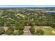 Expansive aerial view of the home nestled within a lush, green golf course community at 3607 Fairfield Dr, Clermont, FL 34711