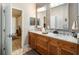 Bathroom boasts double sinks, granite countertops, wood cabinets, and recessed lighting at 3607 Fairfield Dr, Clermont, FL 34711