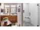 Bathroom boasts a double vanity with granite countertops and a glass enclosed shower with bench seating at 3607 Fairfield Dr, Clermont, FL 34711