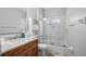 Bathroom features a granite countertop, a shower-tub combo, and modern fixtures at 3607 Fairfield Dr, Clermont, FL 34711