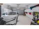 Clean garage with epoxy floors, lots of cabinet space, overhead storage racks, and a car at 3607 Fairfield Dr, Clermont, FL 34711