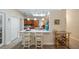Kitchen offers bar seating, stainless sink, wood cabinets, granite countertops, and recessed lighting at 3607 Fairfield Dr, Clermont, FL 34711