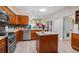 Modern kitchen featuring granite countertops, stainless steel appliances, and ample cabinet space, along with a kitchen island at 3607 Fairfield Dr, Clermont, FL 34711