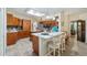Bright kitchen featuring granite countertops, a breakfast bar, ample storage, and stainless steel appliances at 3607 Fairfield Dr, Clermont, FL 34711