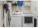 Convenient laundry room with modern washer, dryer, shelving, and cleaning supplies at 3607 Fairfield Dr, Clermont, FL 34711