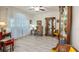 Cozy living room with hardwood floors, sheer curtains, and elegant display cabinet with natural light at 3607 Fairfield Dr, Clermont, FL 34711