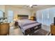 Cozy main bedroom features natural light and a bench at the foot of the bed at 3607 Fairfield Dr, Clermont, FL 34711