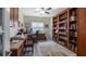 Inviting home office featuring custom built-in cabinets, shelving, wood floors, and stylish decor at 3607 Fairfield Dr, Clermont, FL 34711