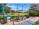 Relaxing screened-in patio featuring comfortable seating, a fountain and a serene golf course view at 3607 Fairfield Dr, Clermont, FL 34711