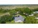 Expansive green spaces and mature trees surround this home, offering privacy and natural beauty at 36535 Eagle Dr, Grand Island, FL 32735