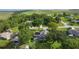 A stunning aerial view showcases this home's landscaped yard, pool, and solar panels at 36535 Eagle Dr, Grand Island, FL 32735
