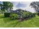 A cozy screened lanai surrounded by lush landscaping provides privacy and outdoor enjoyment at 36535 Eagle Dr, Grand Island, FL 32735
