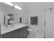 Bright bathroom featuring a gray vanity with a white countertop, a commode, and an enclosed shower at 36535 Eagle Dr, Grand Island, FL 32735