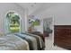 Comfortable bedroom with a large window, ample natural light, and a neutral color palette at 36535 Eagle Dr, Grand Island, FL 32735