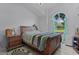Inviting bedroom featuring a large bed, bedside tables, and a bright window view at 36535 Eagle Dr, Grand Island, FL 32735