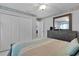 Comfortable bedroom with a dresser, closet, light and tiled floors providing a restful retreat at 36535 Eagle Dr, Grand Island, FL 32735