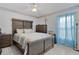 Cozy bedroom featuring wood furniture, natural light, and tiled floors creating a warm and inviting ambiance at 36535 Eagle Dr, Grand Island, FL 32735