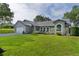 Attractive home with a manicured lawn, lush landscaping, and an attached two-car garage at 36535 Eagle Dr, Grand Island, FL 32735