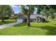 Charming single-story home featuring a well-manicured lawn, an American flag, and a spacious driveway at 36535 Eagle Dr, Grand Island, FL 32735
