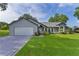 Attractive home boasts arched windows, a well-kept lawn, and a spacious driveway at 36535 Eagle Dr, Grand Island, FL 32735