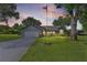 Charming single-story home featuring a well-manicured lawn, an American flag, and a spacious driveway at 36535 Eagle Dr, Grand Island, FL 32735