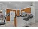 Bright kitchen boasts tile flooring, a breakfast bar with seating, and wood cabinets at 36535 Eagle Dr, Grand Island, FL 32735