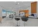 Bright kitchen boasts tile flooring, a breakfast bar with seating, and wood cabinets at 36535 Eagle Dr, Grand Island, FL 32735