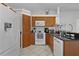 Well-lit kitchen with white appliances, wooden cabinetry, and black granite countertops at 36535 Eagle Dr, Grand Island, FL 32735