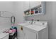 Functional laundry room with washer, dryer, shelving, and ample space at 36535 Eagle Dr, Grand Island, FL 32735