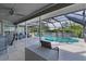 Screened pool with outdoor seating and a covered patio area offering ample space for recreation at 36535 Eagle Dr, Grand Island, FL 32735