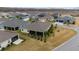 Aerial of a neighborhood with screened lanais, manicured lawns, and proximity to community amenities at 3769 Causey Ct, The Villages, FL 32163