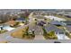Aerial view of home with lush landscaping, pond and other homes in community at 3769 Causey Ct, The Villages, FL 32163