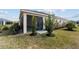 Landscaped backyard featuring a screened-in patio and privacy plantings at 3769 Causey Ct, The Villages, FL 32163