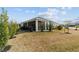 Wide angle view of back of home showing screened in porch and landscaping at 3769 Causey Ct, The Villages, FL 32163