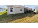 Home's backyard featuring privacy landscaping and view of neighboring home at 3769 Causey Ct, The Villages, FL 32163
