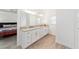 Primary bathroom features double vanity, granite counters, wood-look tile floor, and access to shower at 3769 Causey Ct, The Villages, FL 32163