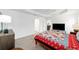 Bright bedroom has neutral walls, wood-look tile flooring, and walk-in closet at 3769 Causey Ct, The Villages, FL 32163