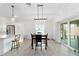 Dining area showcases modern light fixture, tile flooring, and seamless access to the kitchen and outdoor space at 3769 Causey Ct, The Villages, FL 32163