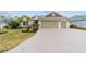 Well-maintained single-story home with a spacious driveway and landscaped front yard at 3769 Causey Ct, The Villages, FL 32163