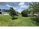 Beautifully maintained front yard with lush green lawn and mature trees at 3769 Causey Ct, The Villages, FL 32163