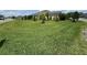 Spacious front yard featuring a well-maintained lawn and trees at 3769 Causey Ct, The Villages, FL 32163