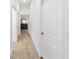 Bright hallway leads to a bedroom, with a glimpse of the dresser, and doors leading to other parts of the house at 3769 Causey Ct, The Villages, FL 32163
