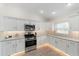 Modern kitchen with stainless steel appliances, stylish backsplash, and ample counter space for cooking at 3769 Causey Ct, The Villages, FL 32163