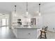 Bright, open kitchen with stone countertops, stainless steel appliances, and large island with seating at 3769 Causey Ct, The Villages, FL 32163