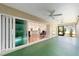 Covered patio featuring a ceiling fan, tiled floors, and sliding doors that open to the kitchen and living area at 3769 Causey Ct, The Villages, FL 32163