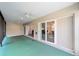 Covered patio with sliding glass doors that lead to interior of the house and two ceiling fans at 3769 Causey Ct, The Villages, FL 32163