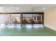 This screened lanai offers shade and keeps bugs out, with a green floor and view of the neighborhood at 3769 Causey Ct, The Villages, FL 32163