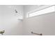 Bright walk-in shower features white tile and convenient storage niche at 3769 Causey Ct, The Villages, FL 32163