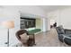 Cozy sunroom with comfortable wicker chair, tile flooring, and view to the lanai for relaxed living at 3769 Causey Ct, The Villages, FL 32163