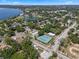An aerial photo showcasing a community tennis court, homes, and the nearby lake at 378 W Osceola St, Clermont, FL 34711